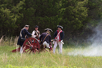 Revolutionary War reenactors firing the Rutgers cannon
