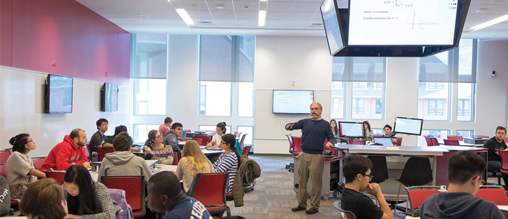 Professor teaching a class in an active learning classroom