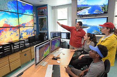 Professor showing students ocean data at Center for Ocean Observing Leadership